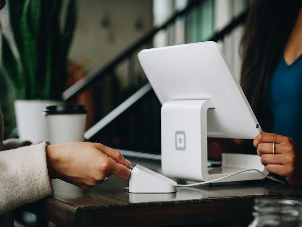 Small business owner taking a payment at the counter